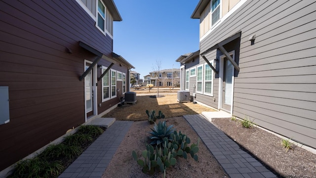 exterior space with fence, a residential view, and central AC