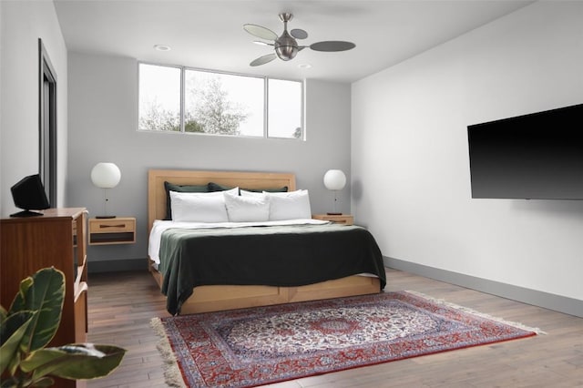 bedroom featuring recessed lighting, baseboards, wood finished floors, and a ceiling fan