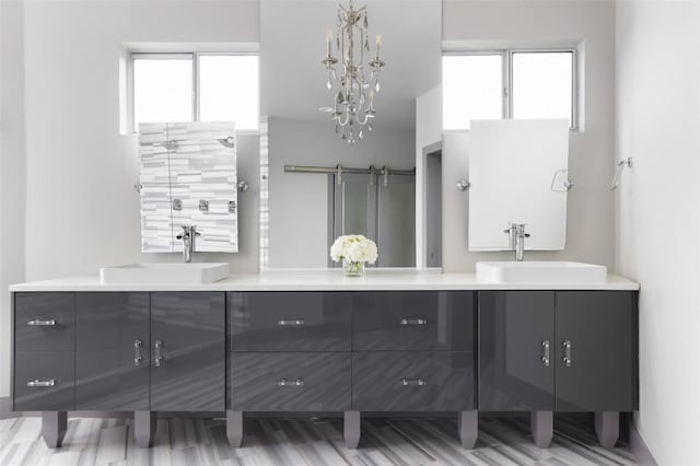 bathroom featuring double vanity, plenty of natural light, and a sink