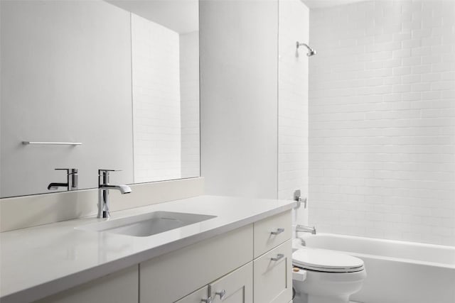 bathroom featuring toilet, vanity, and shower / tub combination