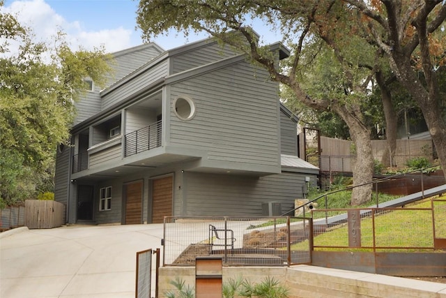 exterior space with a balcony and a fenced front yard