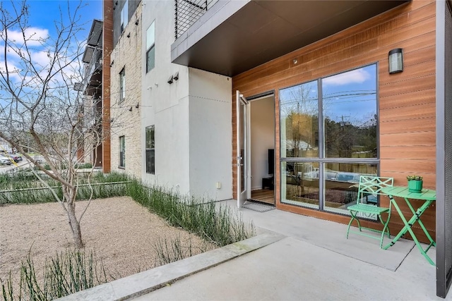 exterior space featuring a patio area and stucco siding