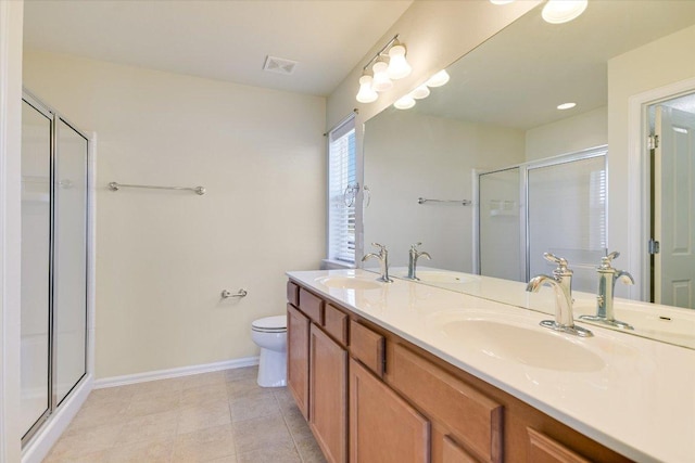 bathroom with a stall shower, visible vents, and a sink