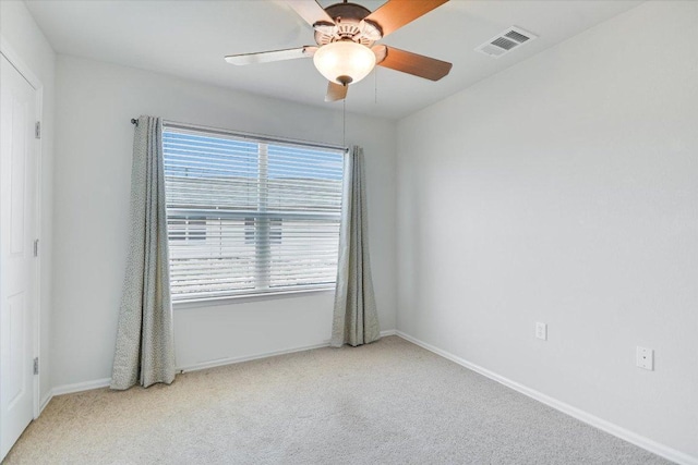 empty room with a ceiling fan, visible vents, carpet floors, and baseboards