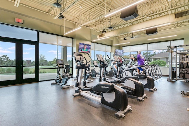 exercise room featuring a high ceiling and visible vents