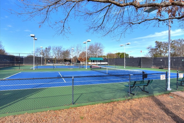 view of tennis court with fence