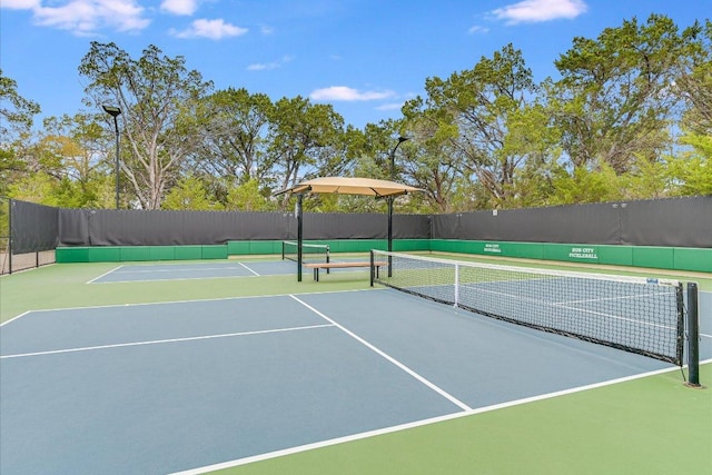 view of tennis court with fence