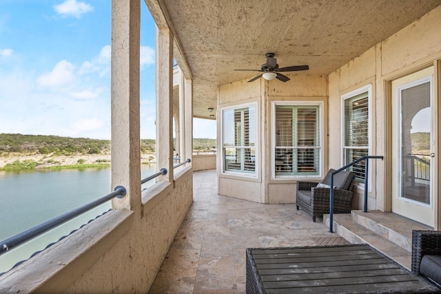 exterior space featuring a water view and ceiling fan