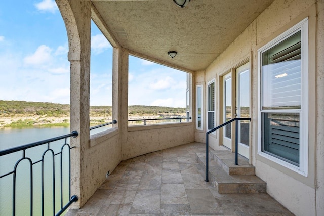 balcony featuring a water view