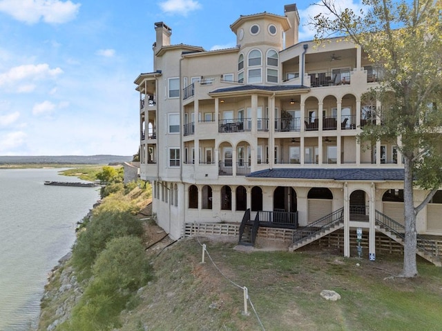 view of property with stairway and a water view