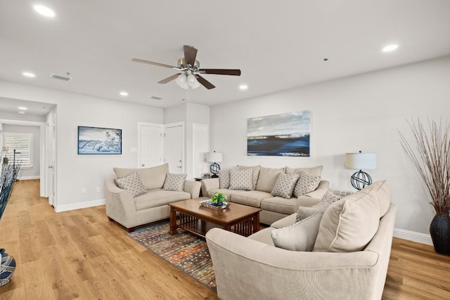 living room featuring recessed lighting, light wood-type flooring, and baseboards