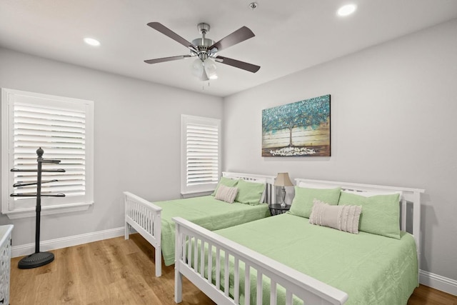 bedroom with recessed lighting, baseboards, wood finished floors, and a ceiling fan