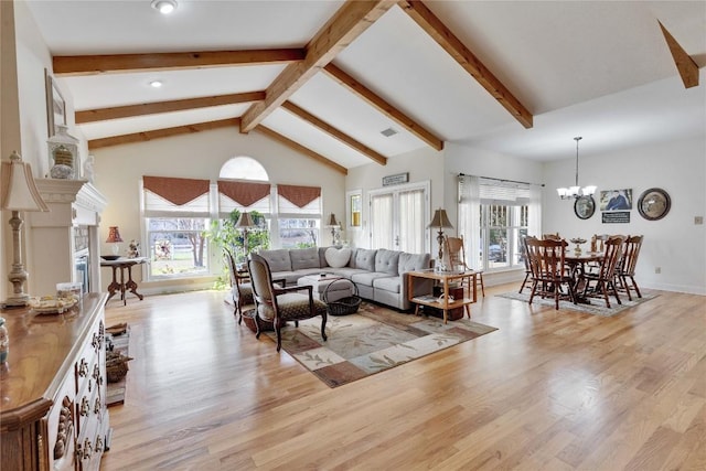 living room with an inviting chandelier, beamed ceiling, light wood finished floors, and high vaulted ceiling