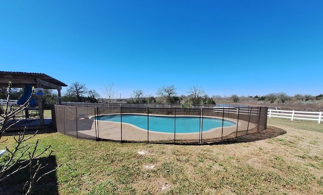 view of pool featuring a fenced in pool, a lawn, and fence