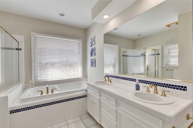 681 Leisure Ln, Cedar Creek, TX 78612 - bathroom featuring a garden tub, double vanity, a shower stall, tile patterned flooring, and recessed lighting