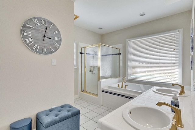 full bath with a bath, tile patterned floors, a sink, and a stall shower