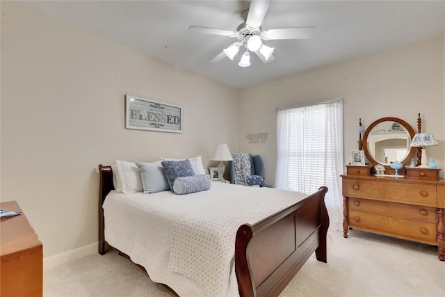 bedroom with ceiling fan, baseboards, and light colored carpet