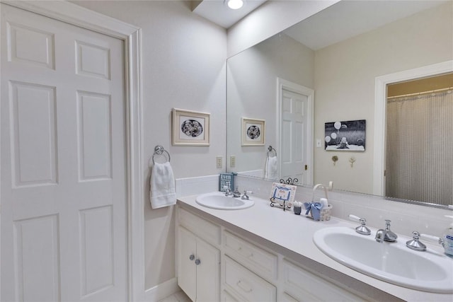 full bath with double vanity and a sink