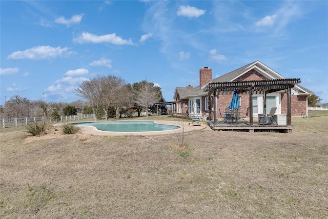 outdoor pool with fence, a pergola, a lawn, and a deck