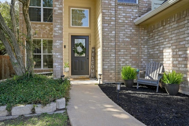 view of exterior entry with brick siding