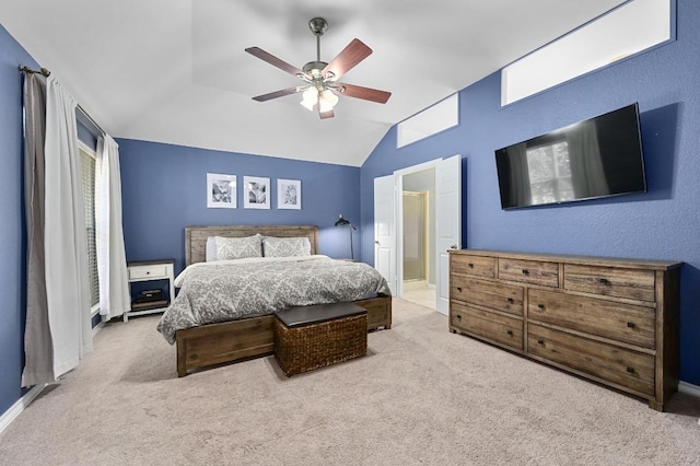 bedroom with a ceiling fan, connected bathroom, carpet, baseboards, and vaulted ceiling