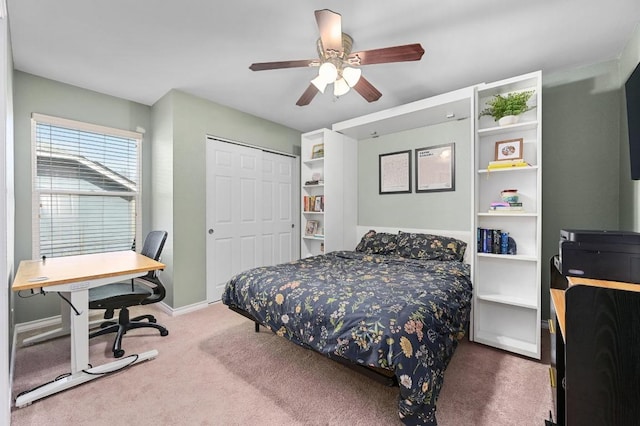 bedroom with carpet flooring, baseboards, a closet, and ceiling fan