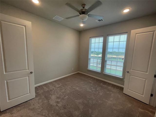 spare room featuring recessed lighting, carpet flooring, baseboards, and visible vents