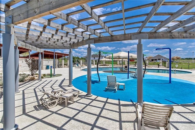 view of swimming pool with a patio and a pergola