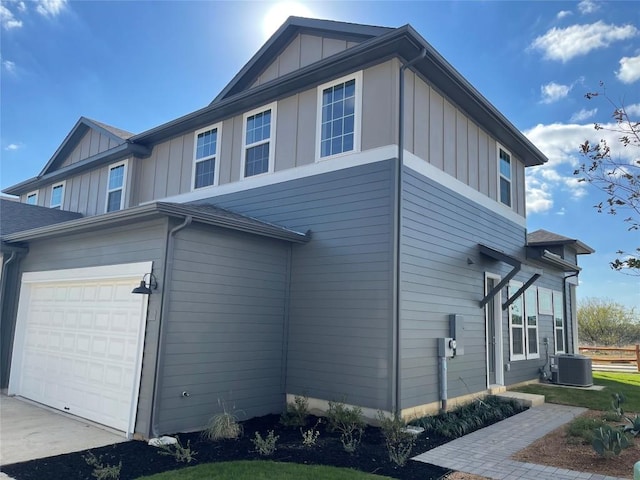 view of home's exterior featuring board and batten siding and central AC