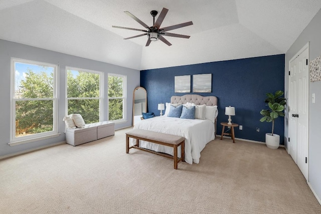 carpeted bedroom with ceiling fan, vaulted ceiling, baseboards, and a textured ceiling