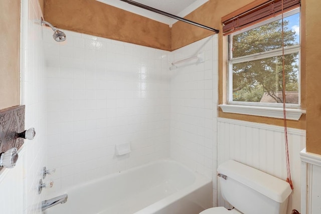 full bath featuring a wainscoted wall, shower / washtub combination, and toilet