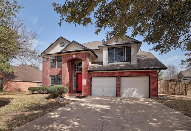 traditional-style house with brick siding, driveway, a garage, and fence