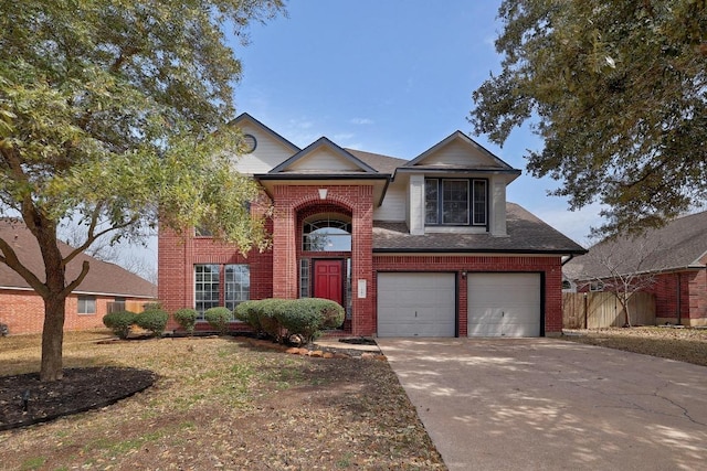 traditional home with brick siding, an attached garage, a shingled roof, fence, and driveway