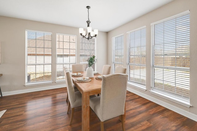 dining room with baseboards, a chandelier, and dark wood-style flooring