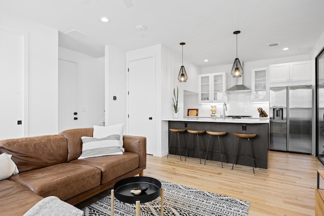 living room featuring light wood finished floors and recessed lighting