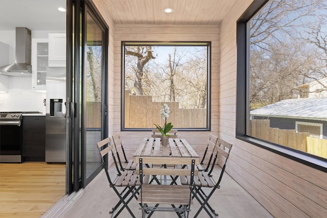 unfurnished sunroom with wood ceiling