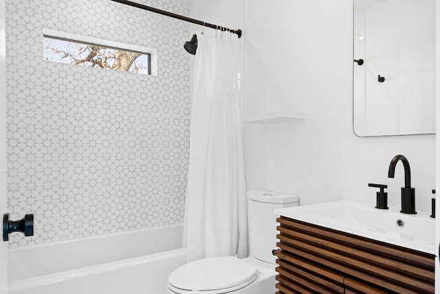 bathroom featuring toilet, shower / bathtub combination with curtain, and vanity