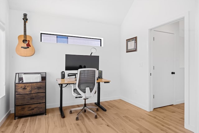 office area with baseboards, lofted ceiling, and wood finished floors