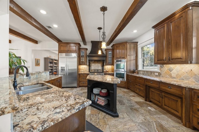 kitchen with custom range hood, a sink, open shelves, a center island, and stainless steel appliances