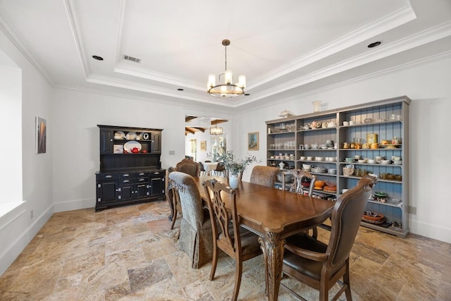 dining space with visible vents, stone finish flooring, a raised ceiling, and an inviting chandelier