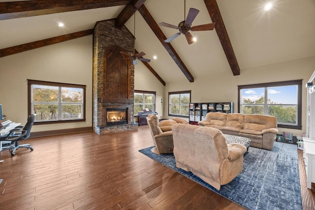 living room with a large fireplace, high vaulted ceiling, wood finished floors, and a ceiling fan