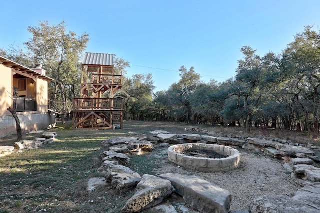 view of yard featuring a fire pit and a playground