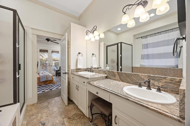 bathroom featuring a stall shower, crown molding, french doors, and a sink