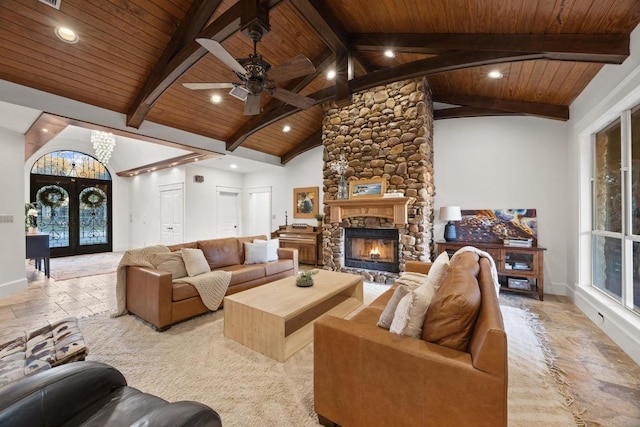 living room with a stone fireplace, french doors, wood ceiling, and stone tile floors