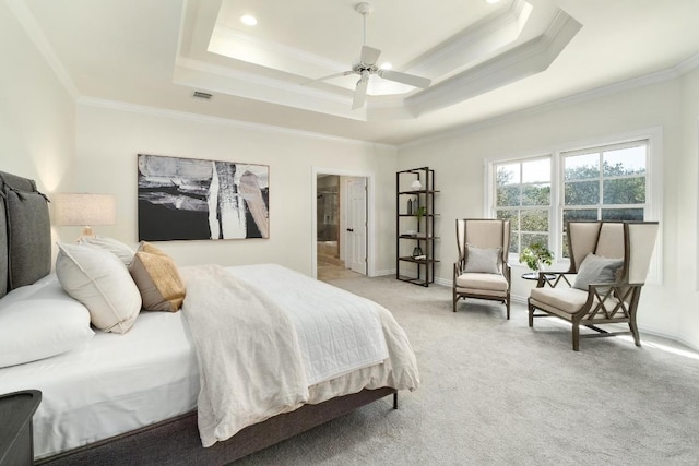 bedroom featuring a tray ceiling, crown molding, baseboards, and light carpet