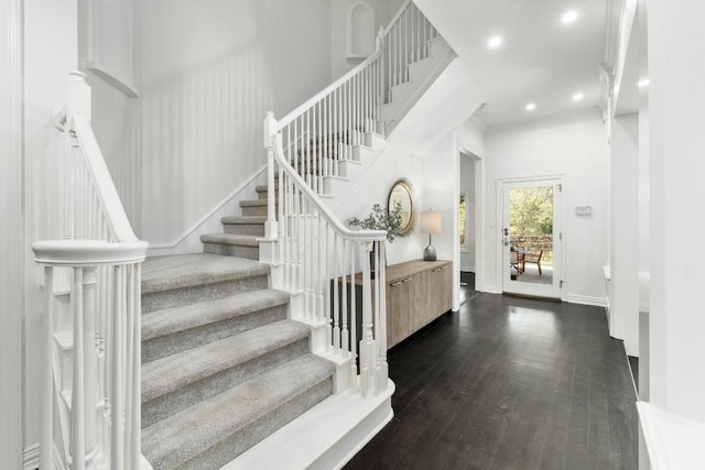 entryway with stairway, recessed lighting, dark wood-style floors, and baseboards