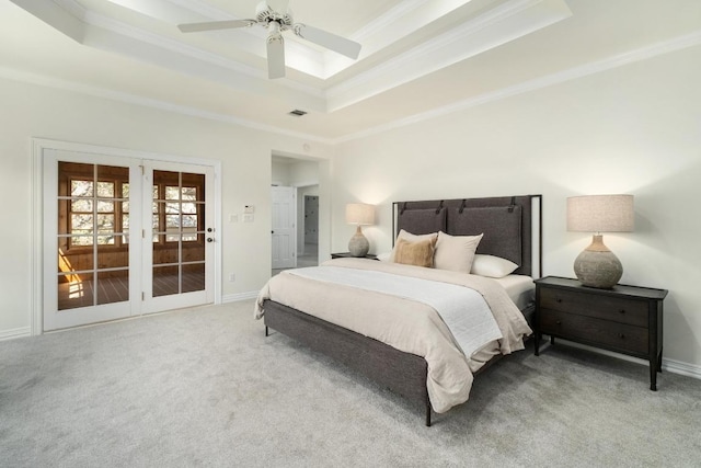 bedroom featuring carpet, a raised ceiling, crown molding, and baseboards