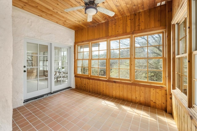 unfurnished sunroom with wooden ceiling and a ceiling fan