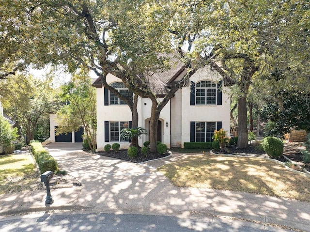 view of front facade featuring stucco siding, a garage, and concrete driveway