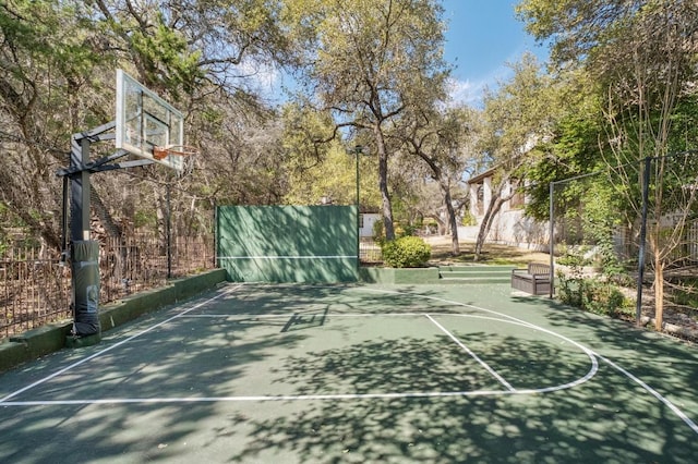 view of basketball court featuring community basketball court and fence